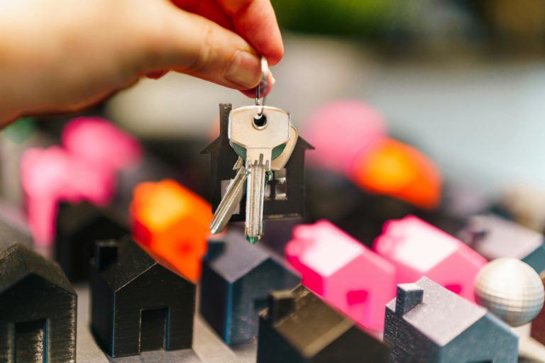 keys to a property and small house models